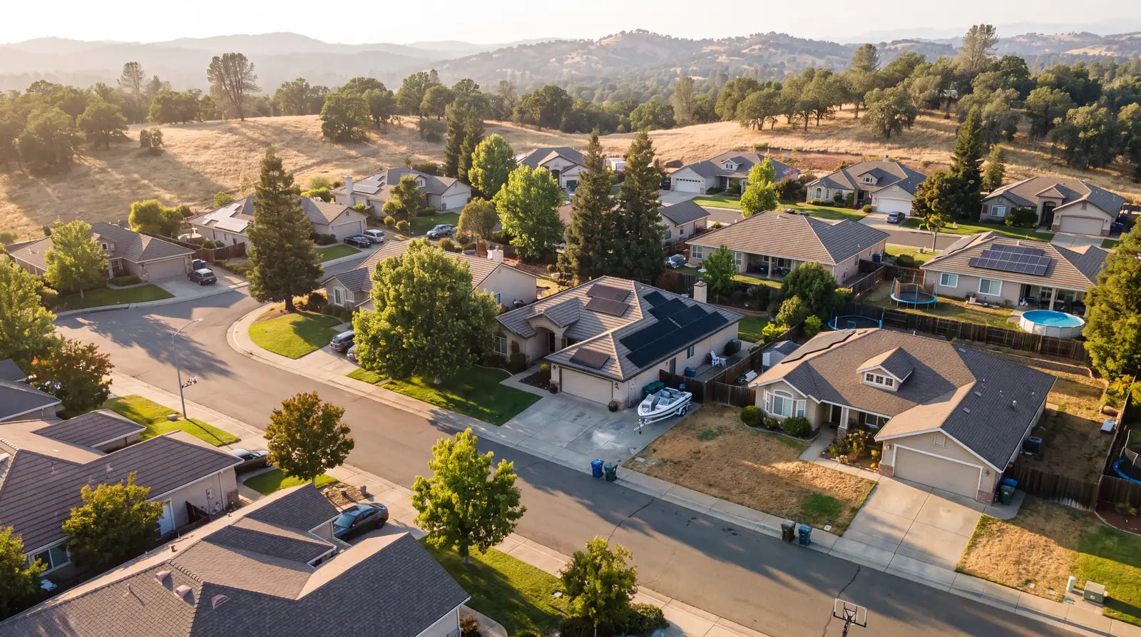 Aerial view of a Sacramento foothills neighborhood with rooftop solar systems