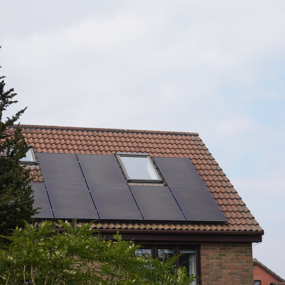 Residential solar panels installed on a roof by Senga Energy, with battery storage options to lower monthly electric bills in California